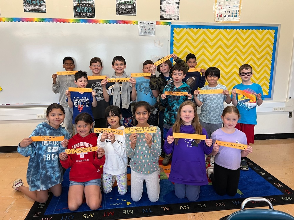 Students holding their orange chain links