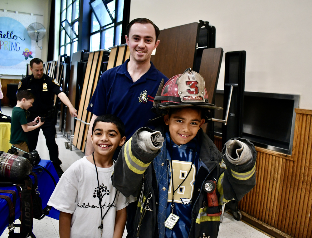 Two students with Bethpage firefighter
