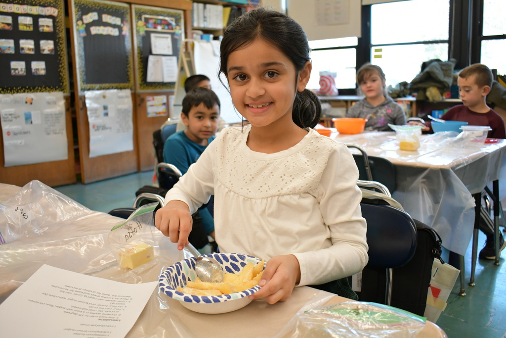 Girl mixing her apple pie ingredients 
